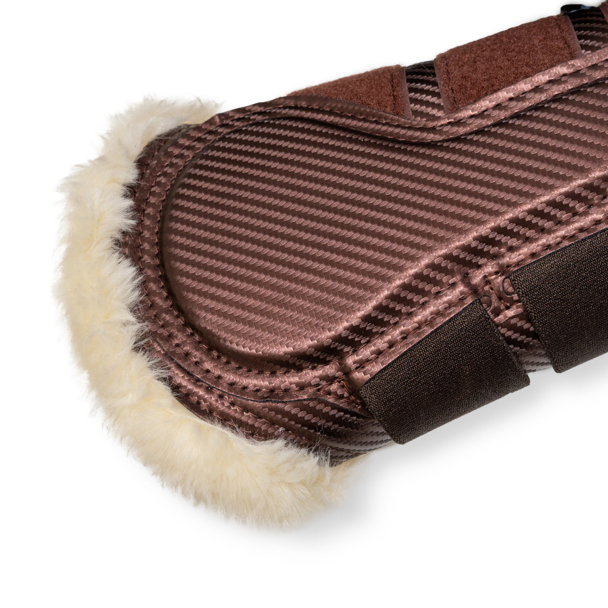 Brown brushing boots with natural fur padding on a white background