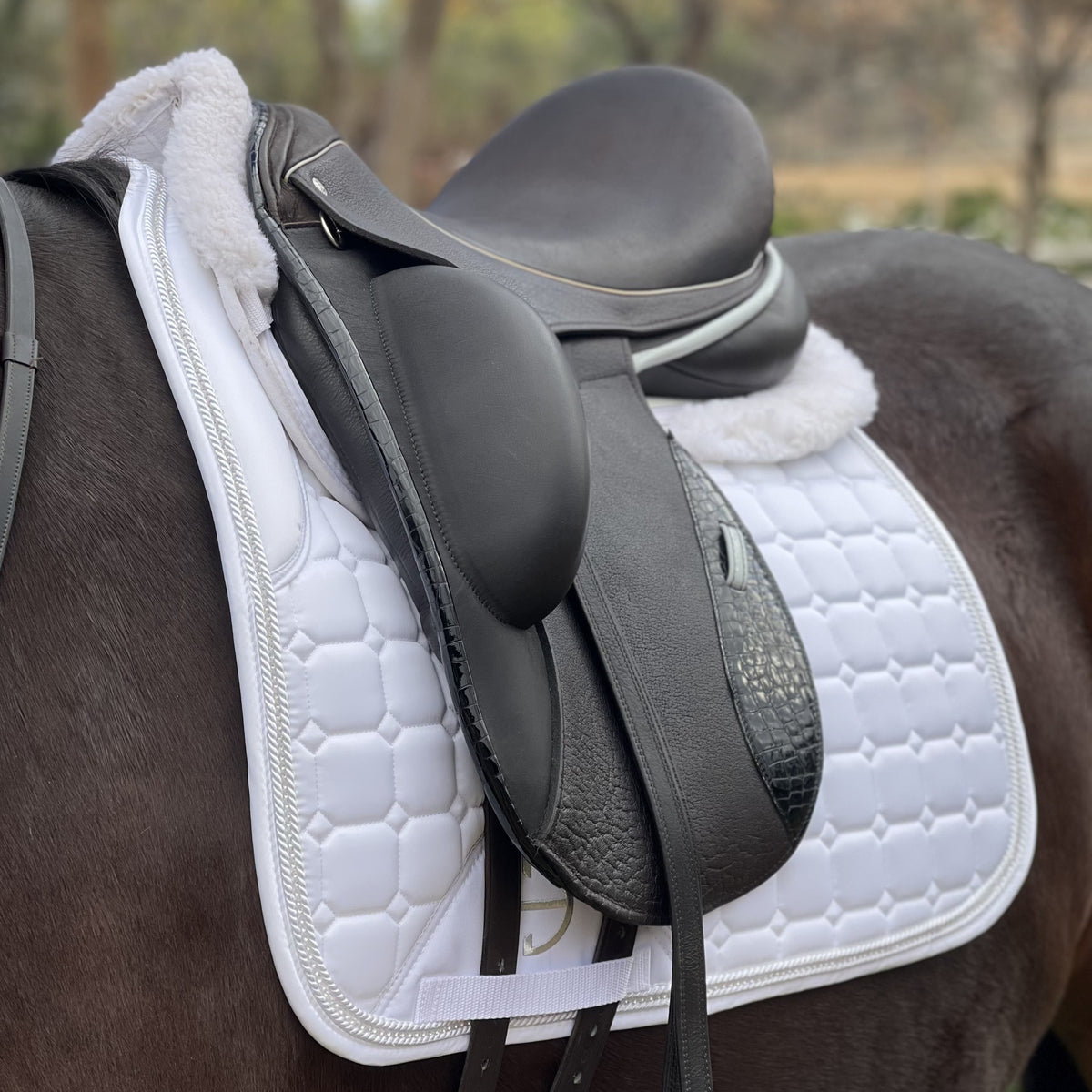 White satin quilted dressage saddle pad with crystals and white satin rope trim