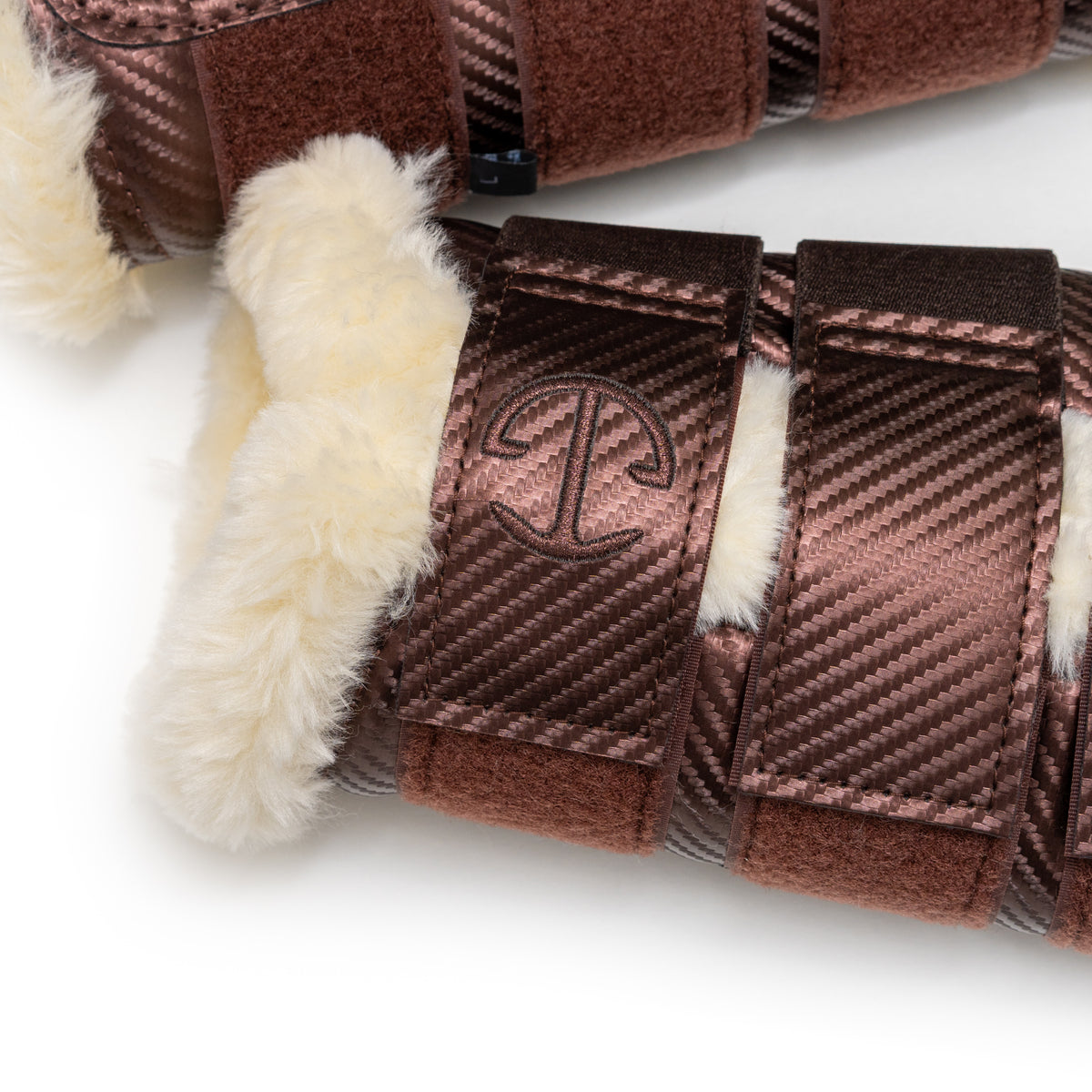 Close-up of brown brushing boots with  Halter Ego brand logo on a white background