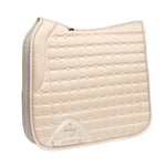 Warm Ivory quilted saddle pad with a brand logo on a white background